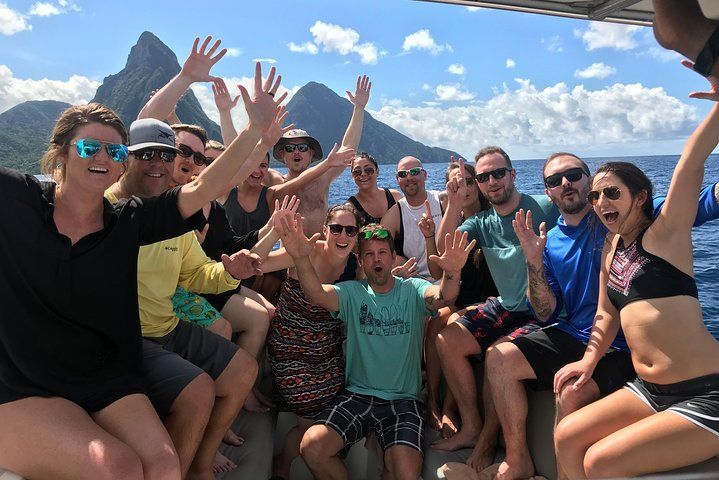 A group of people are sitting on a boat in the ocean.