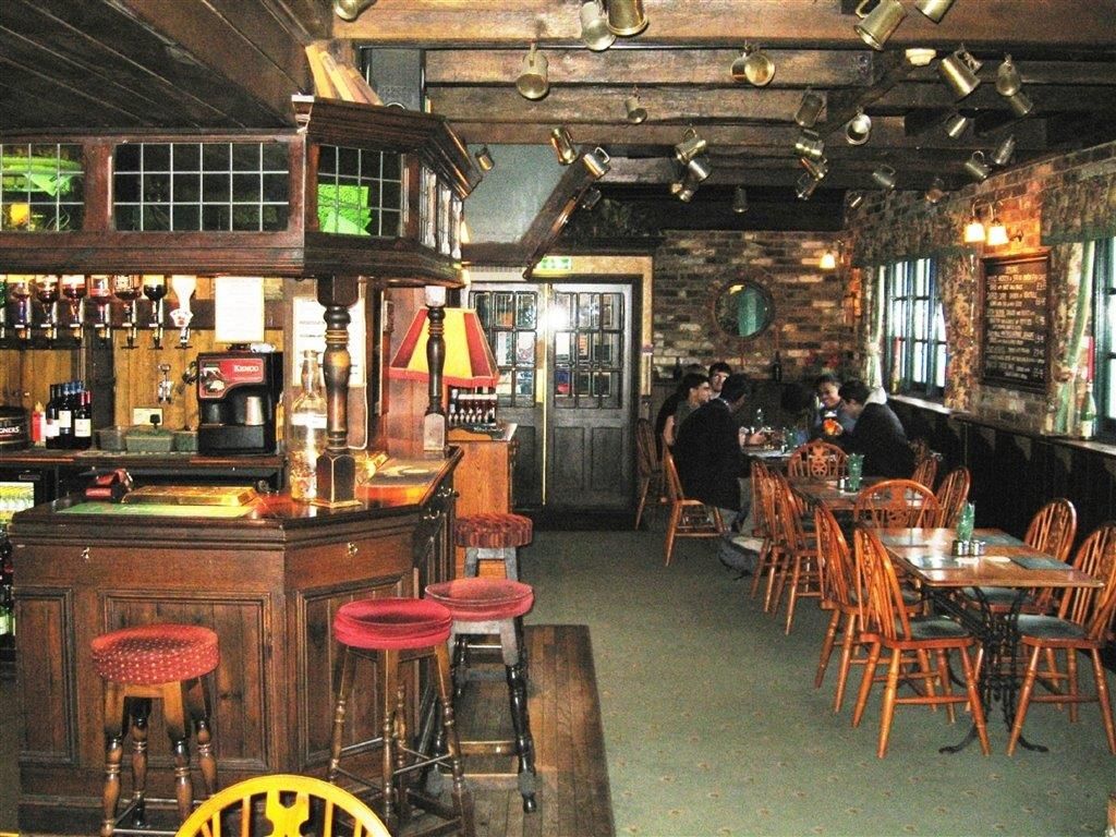 A restaurant with tables and chairs and a bar