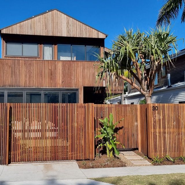 Two-Story Wood House with Matching Slat Fence — Byron & Beyond Fencing in Billinudgel, NSW