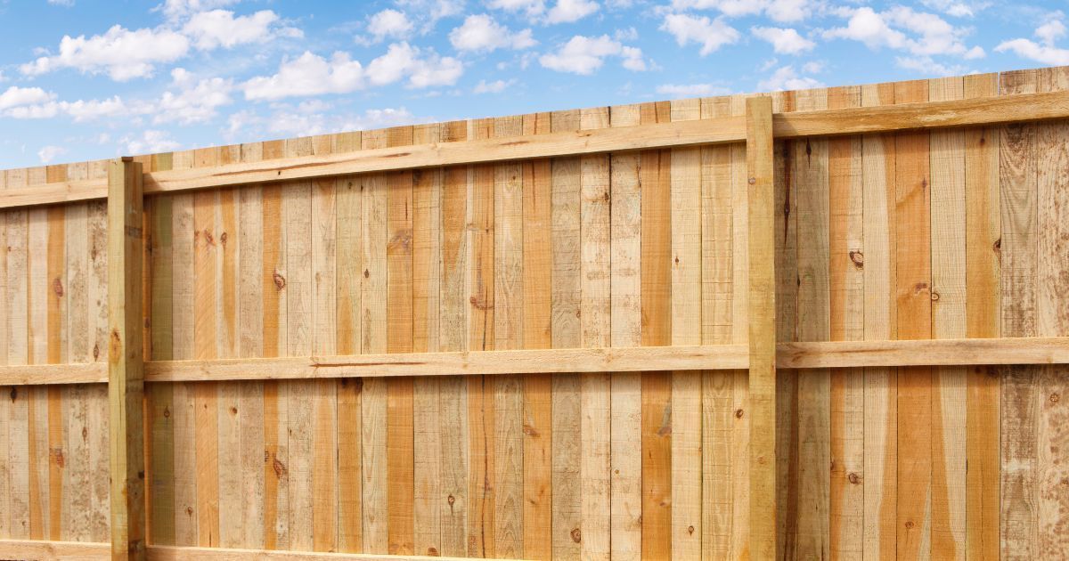 A Wooden Fence with A Blue Sky in The Background — Byron & Beyond Fencing In Billinudgel, NSW