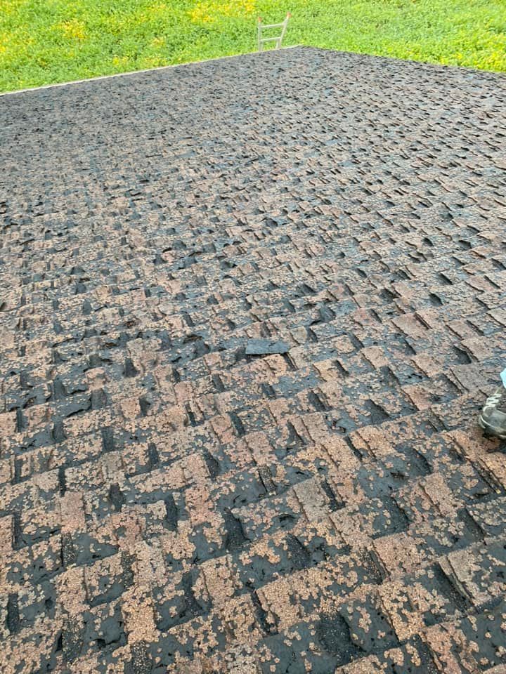 A close up of a roof with a lot of shingles on it.