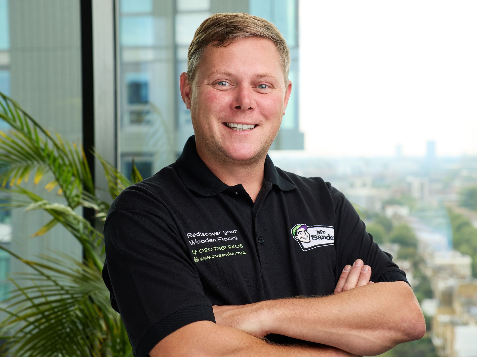 Man with a beard in front of a van with 