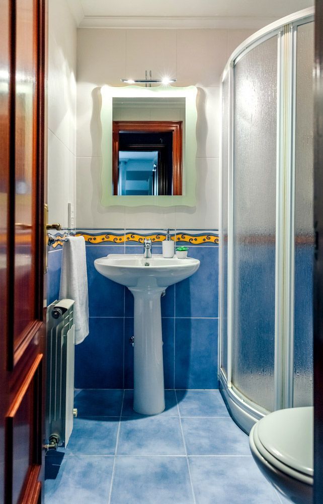 Interior Of Small Bathroom With Mirror And Shower Screen — Glass Repairs & Installations in Scone, NSW