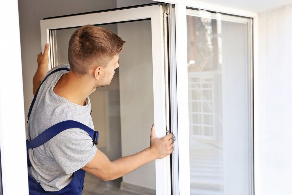 Construction Worker Installing WIndow In House — Glass Door & Window Installation in Taminda, NSW