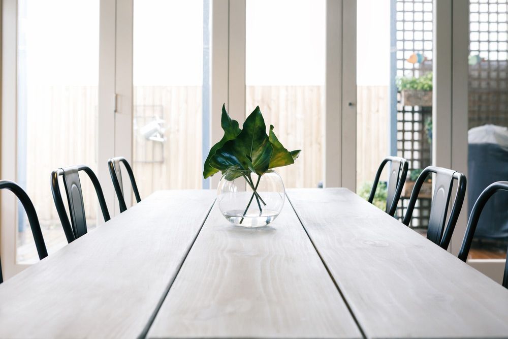 View Dinning Room Table With Bi Fold Window And Door — Glass Repairs & Installations in Scone, NSW