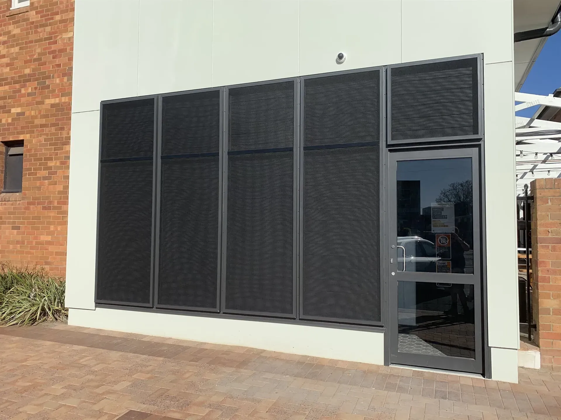 Construction Worker Installing Window In House — Glass Repairs & Installations in Taminda, NSW