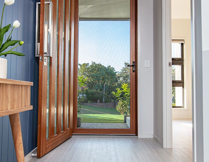 Wooden Front Door And Windows Of A Home — Glass Repairs & Installations in Taminda, NSW