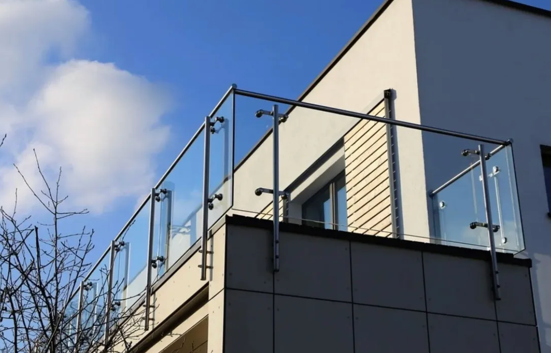 Glass balustrade on the second story of an apartment building.