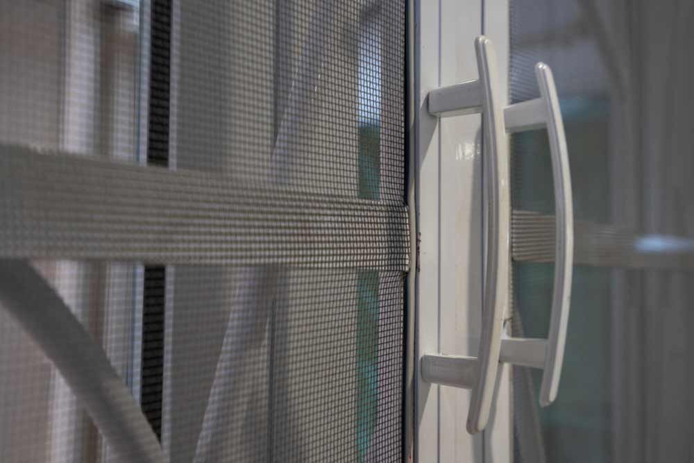 Security Screen Doors With White Handle — Glass Repairs & Installations in Taminda, NSW