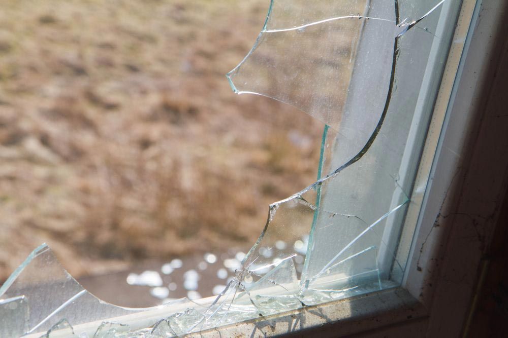 A Window With Broken Glass — Glass Repairs & Installations in Taminda, NSW