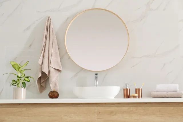 Bathroom Sink With Round Mirror And A Towel — Mirrors & Splashbacks in Taminda, NSW