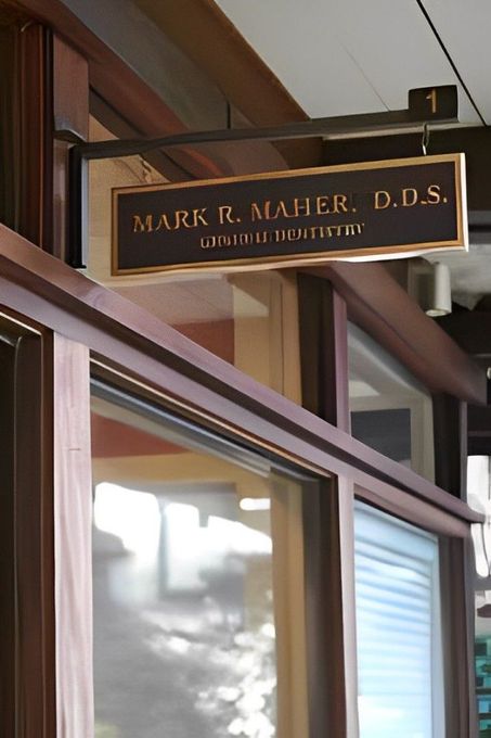 A sign for mark r. maher d.d.s. hangs above a doorway