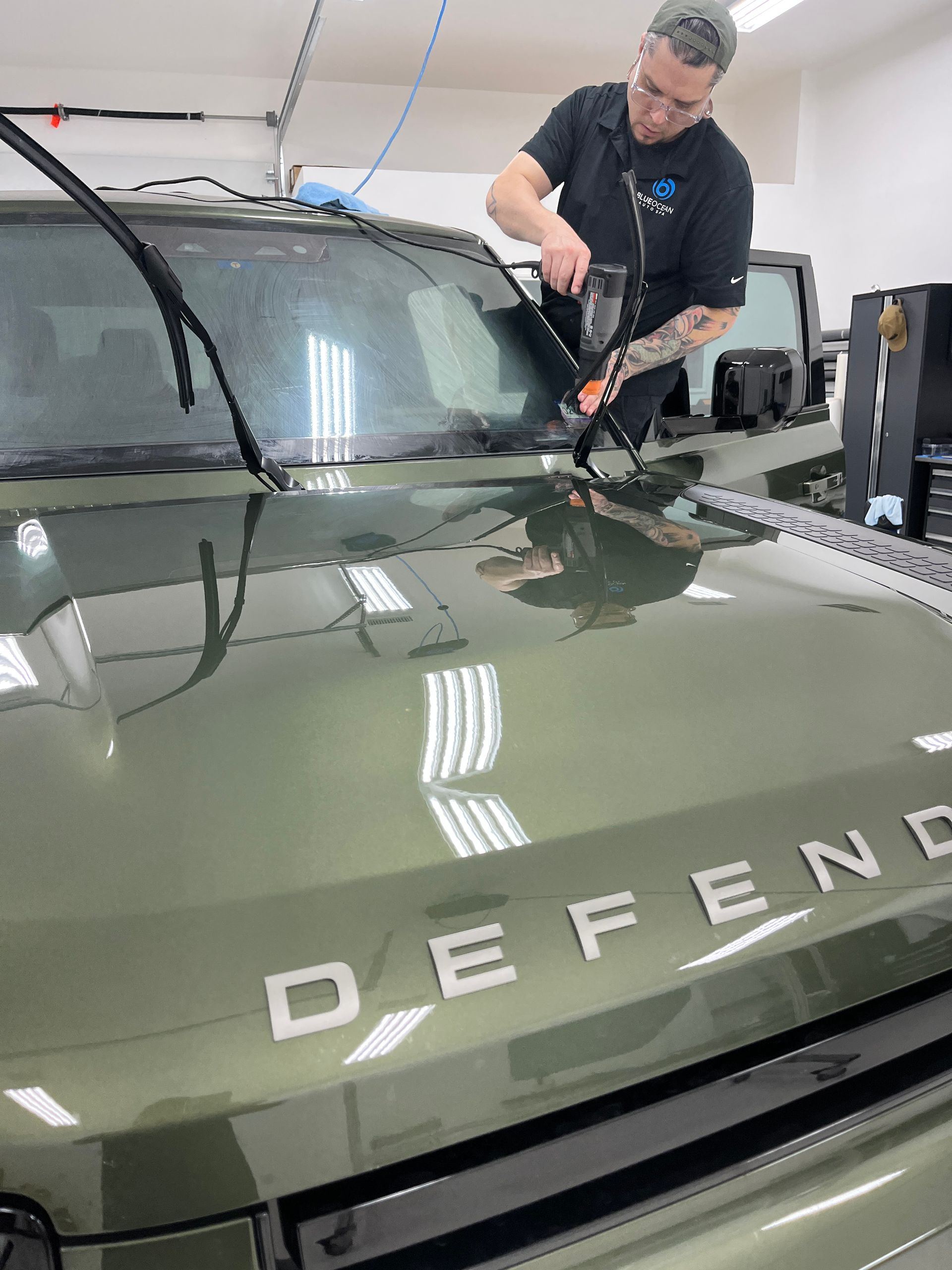 Here the XPEL certified window tint technician is preparing the ceramic window tint to be applied to the inside of the windshield.  This is the heat-shrinking step and requires training and experience to be done right.
