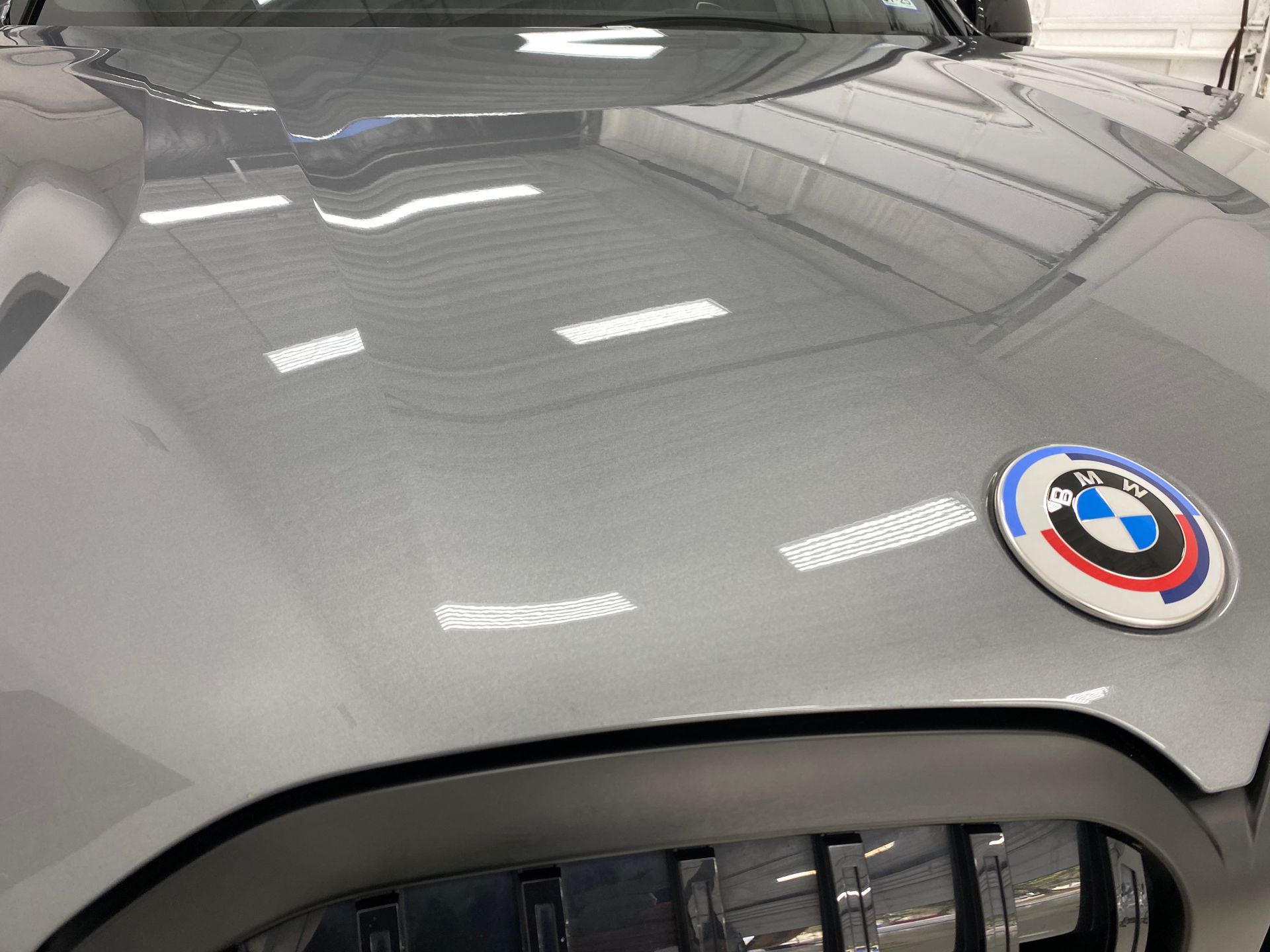 A close up of the hood of a car with a bmw logo on it.