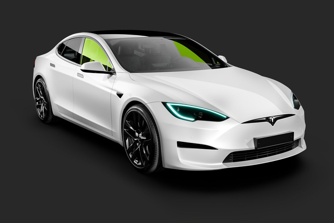 A white tesla model s with blue headlights on a black background.