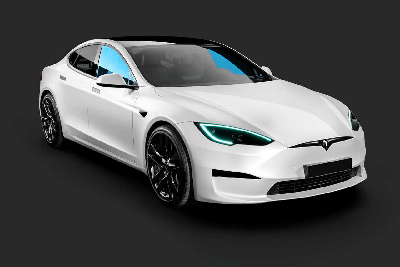 A white tesla model s with blue headlights on a black background.