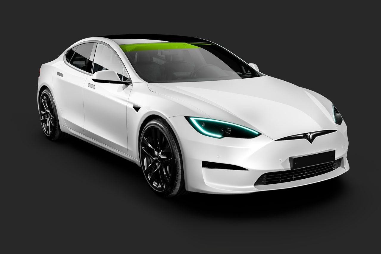 A white tesla model s with blue headlights is on a black background.