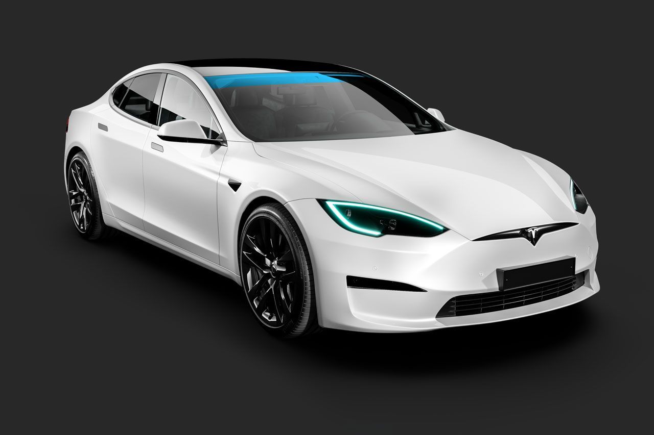 A white tesla model s with blue headlights is on a black background.