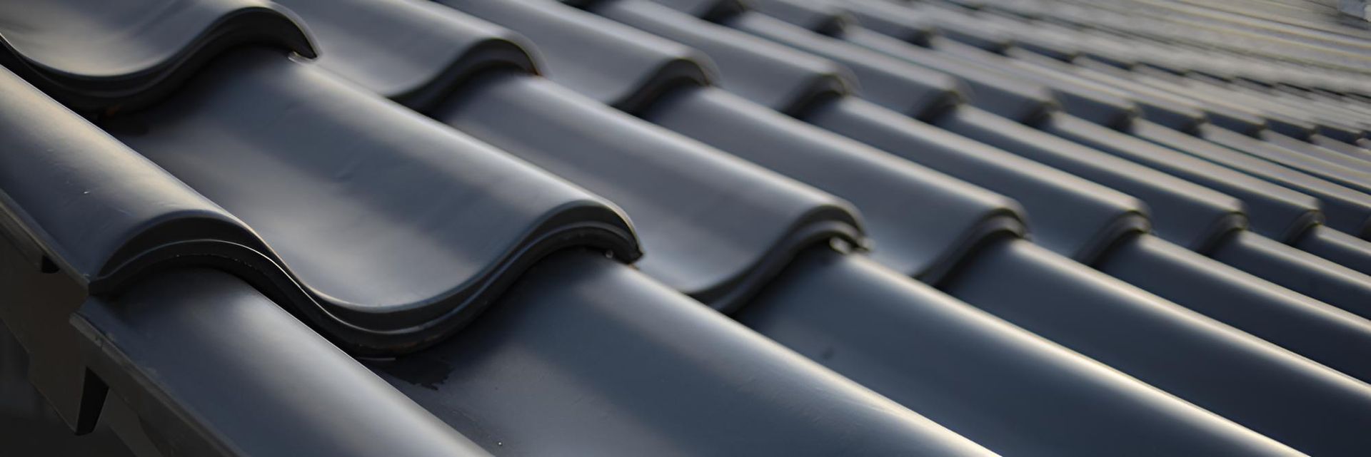 Close Up of a Row of Black Tiles on a Roof — Mr Roof Tiles in Kingscliff, NSW