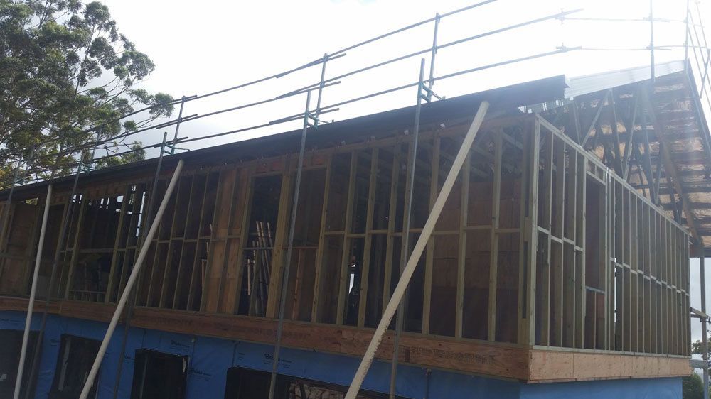 A Building Under Construction With Scaffolding on the Roof   — Mr. Roof Tiles in Kingscliff, NSW