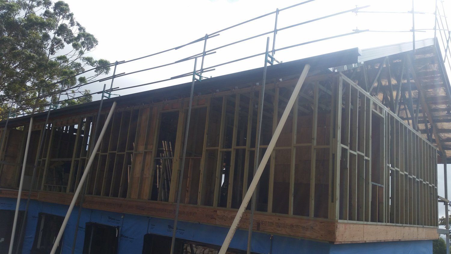 A Building Under Construction With Scaffolding on the Roof — Mr Roof Tiles in Kingscliff, NSW