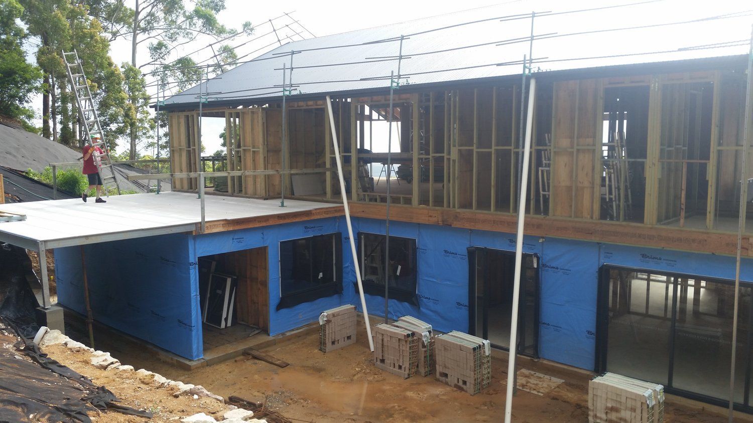 A Large House is Being Built on Top of a Dirt Hill — Mr Roof Tiles in Kingscliff, NSW