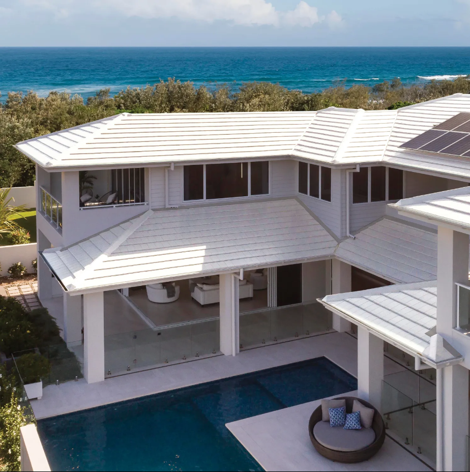 An Aerial View of a Large White House With a Swimming Pool — Mr Roof Tiles in Tweed Heads, NSW