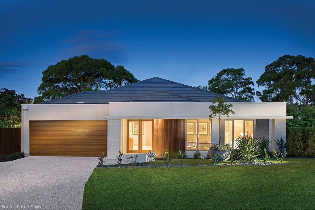 A White House With a Blue Roof and a Wooden Garage Door — Mr Roof Tiles in Kingscliff, NSW