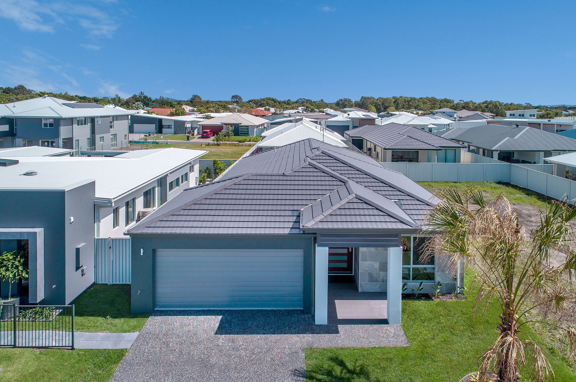 An Aerial View of a House With a Gray Roof in a Residential Area — Mr Roof Tiles in Kingscliff, NSW