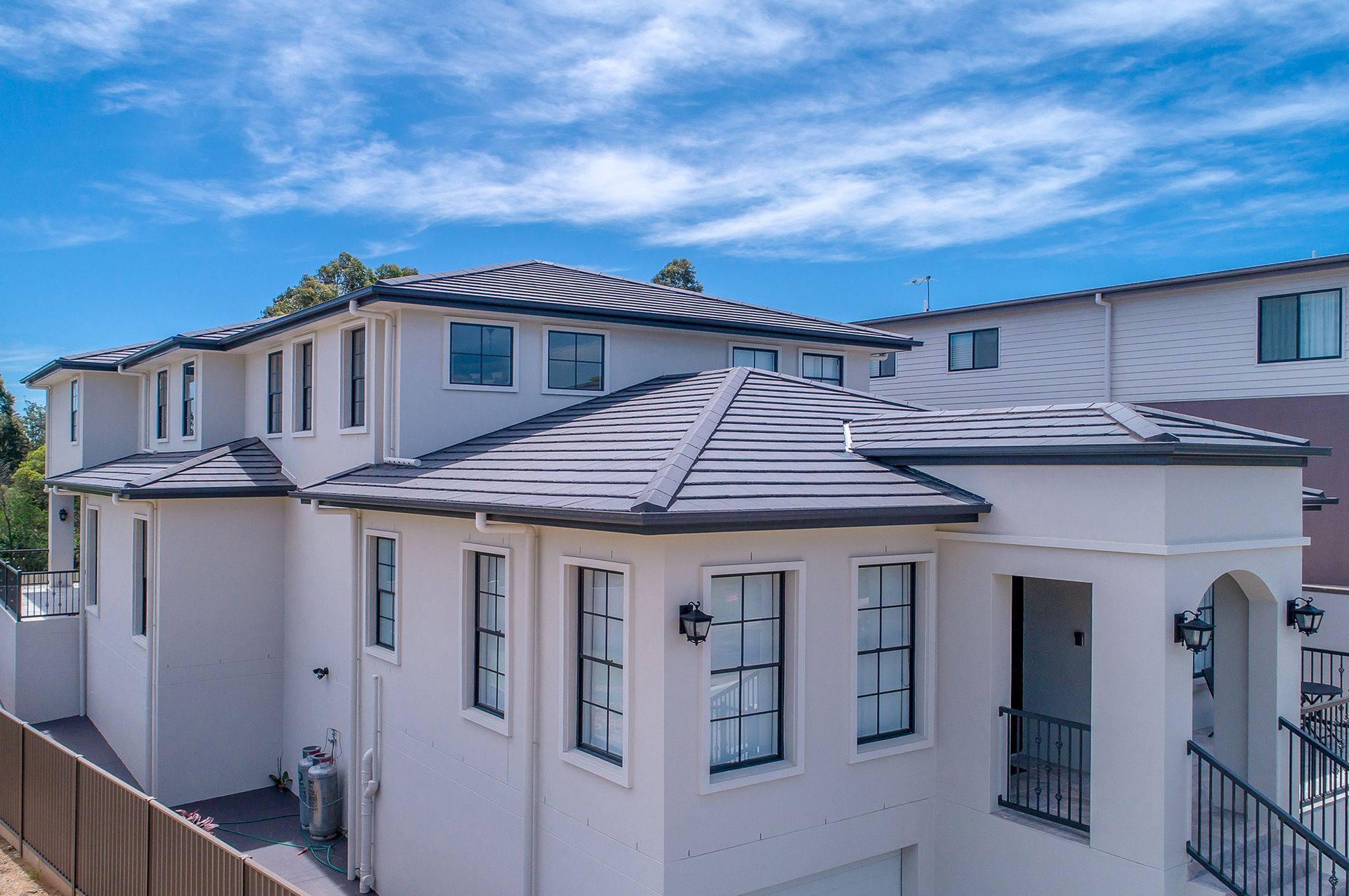 An Aerial View of a White House With a Tiled Roof — Mr Roof Tiles in Kingscliff, NSW