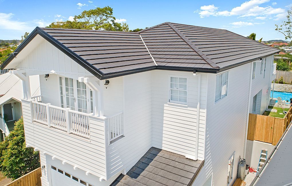 An Aerial View of a White House With a Black Roof — Mr Roof Tiles in Kingscliff, NSW