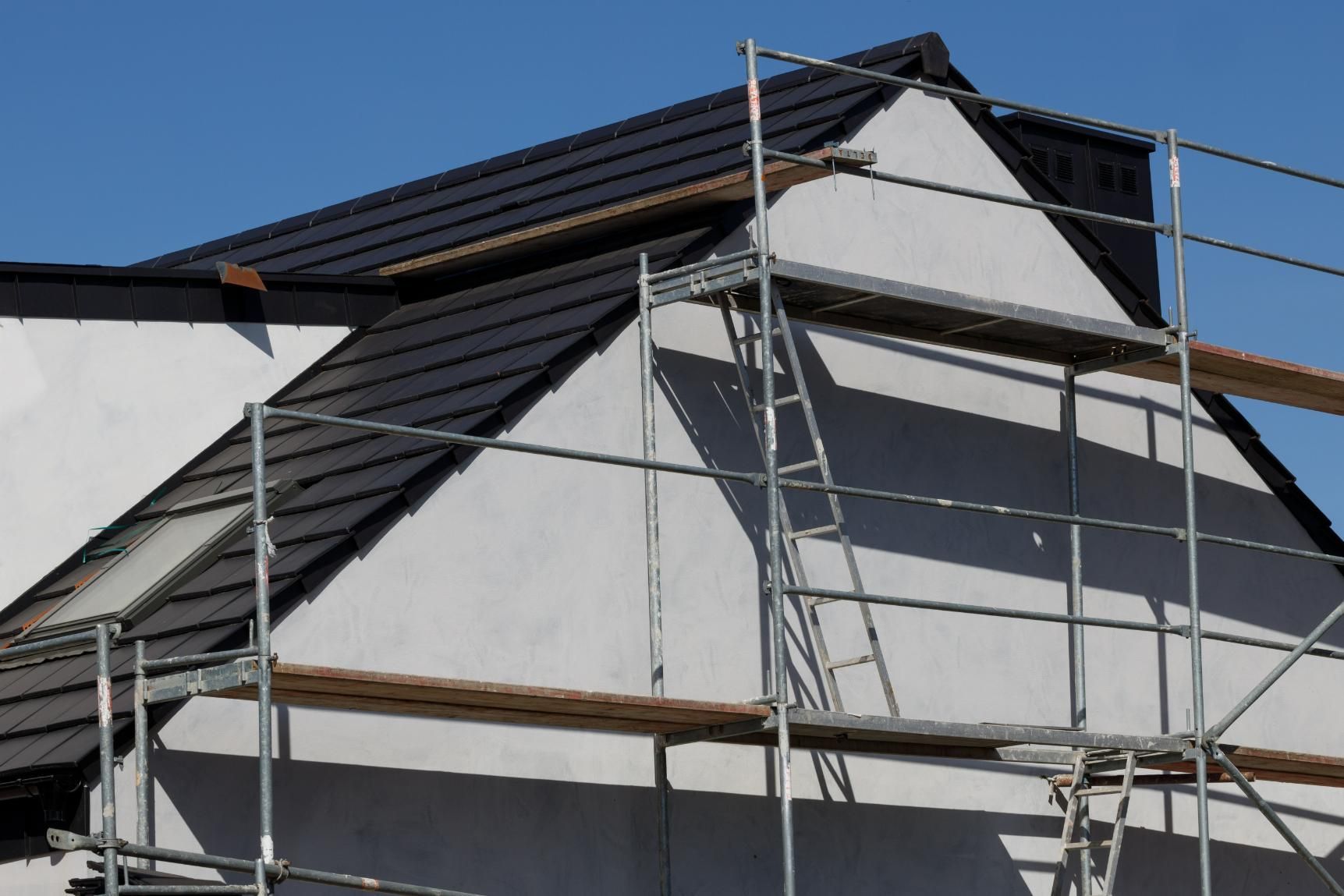 A House is Being Built With Scaffolding Around It — Mr. Roof Tiles in Kingscliff, NSW