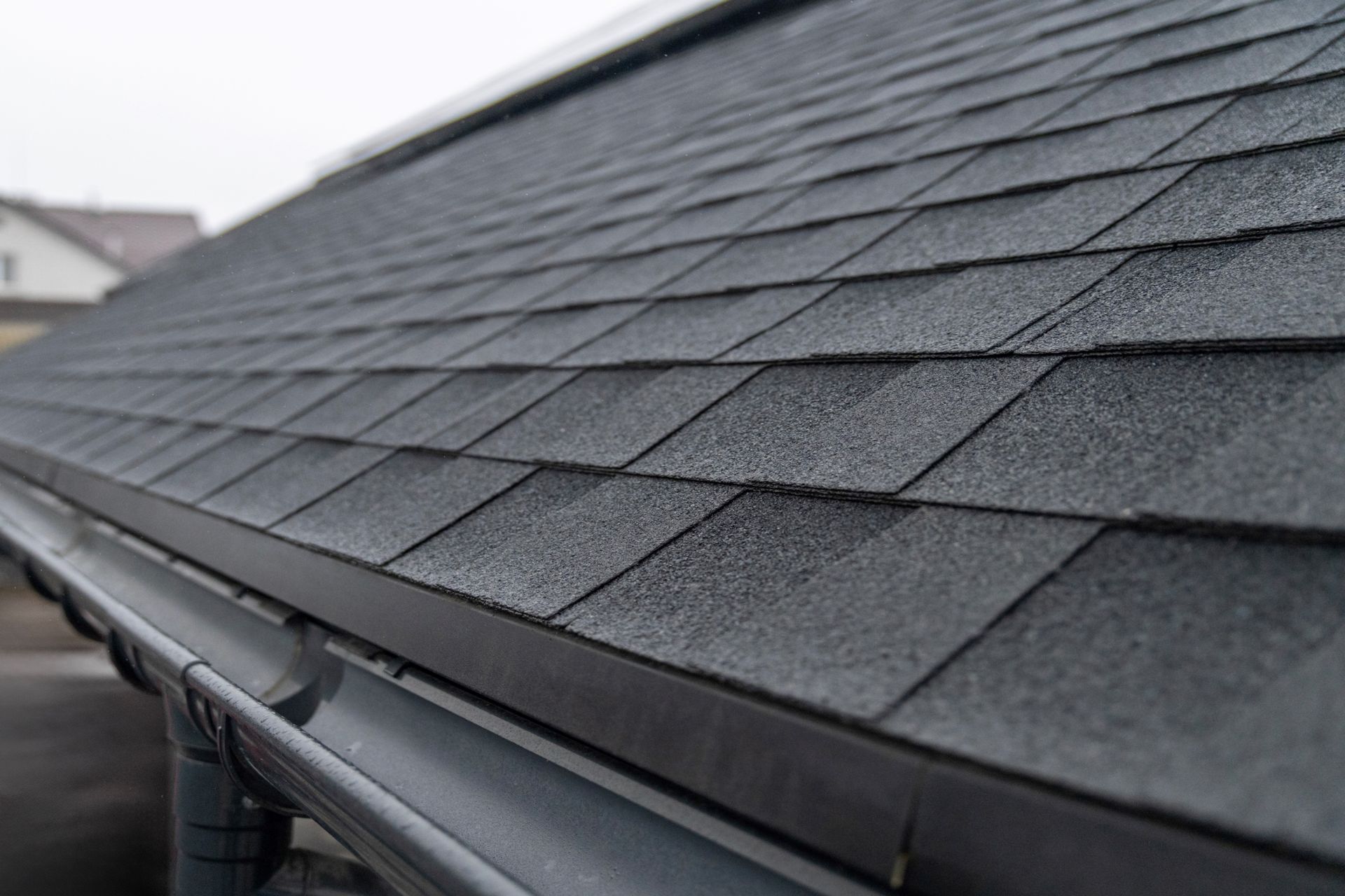 Dark gray asphalt roof shingles. Dark gray asphalt roof shingles.