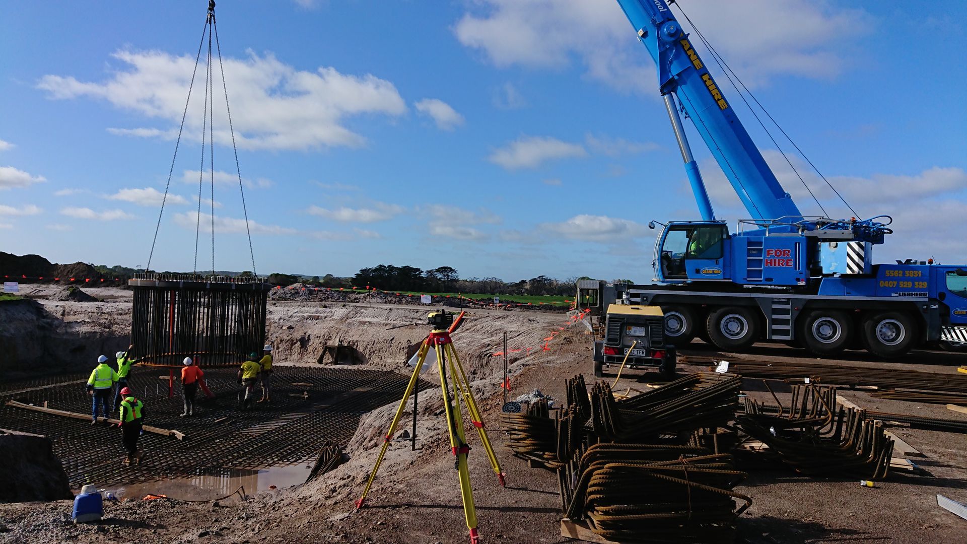 A Man And A Woman Are Sitting At A Table Looking At A Blueprint – Warrnambool, VIC - Joseph Land Surveying