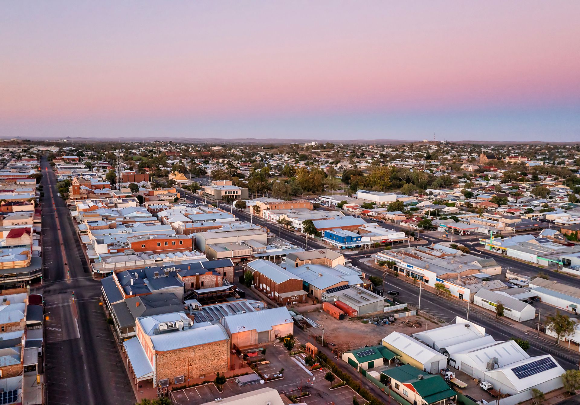 An Aerial View Of A City With Lots Of Buildings And Roads At Sunset – Warrnambool, VIC - Joseph Land Surveying