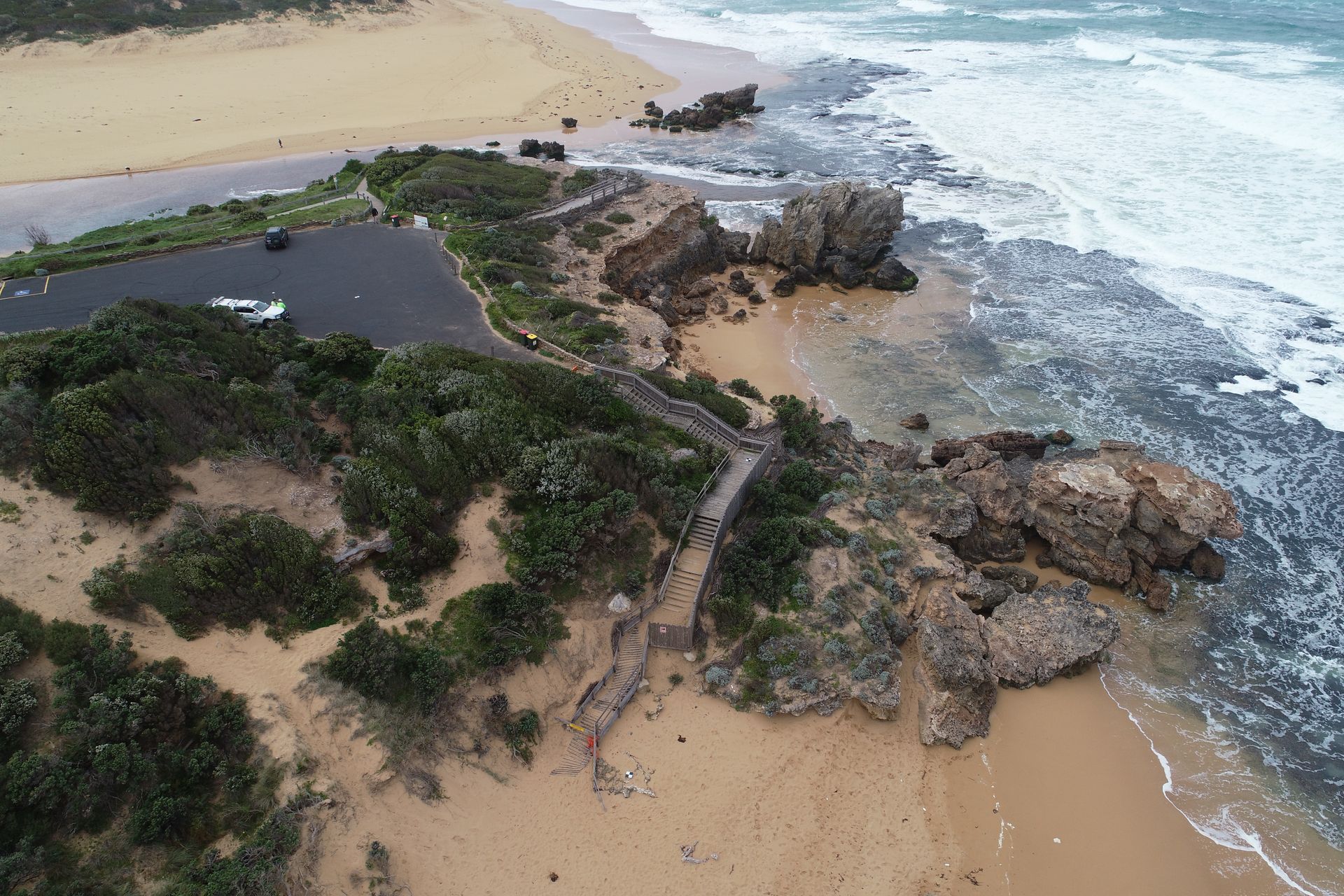 A construction worker is holding a blueprint at a construction site.