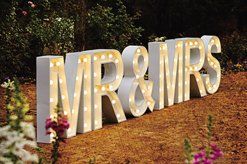 A large sign that says mr and mrs is sitting on the ground.