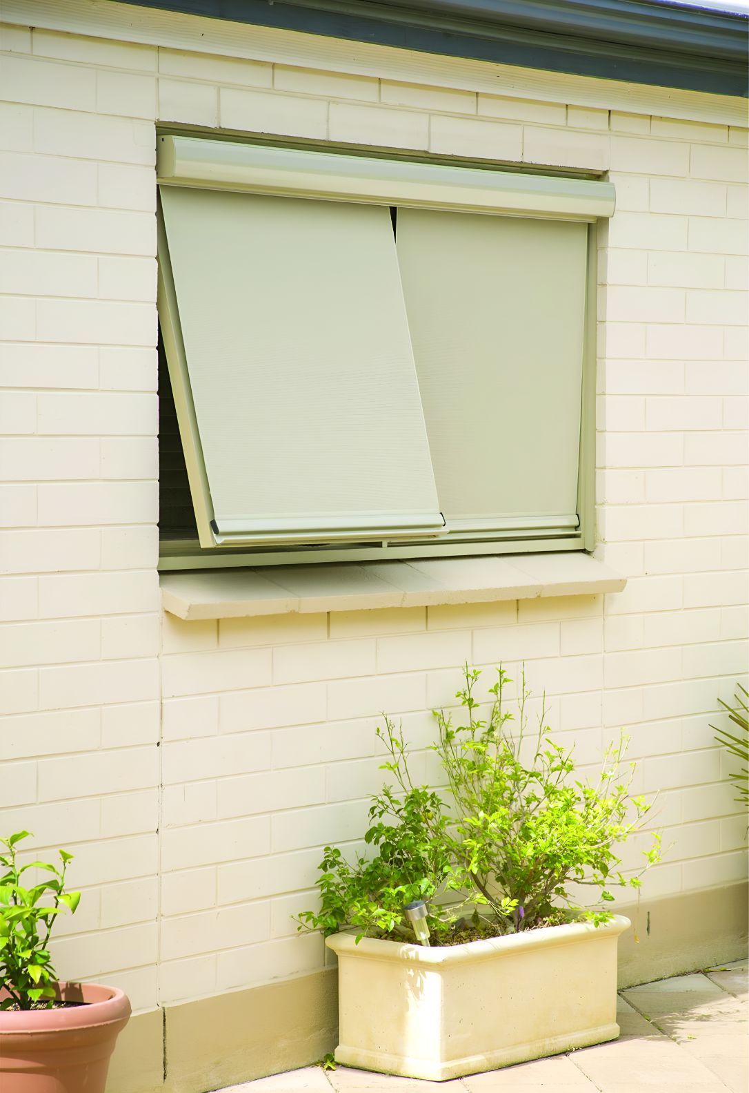 A White Brick Building With a Window That is Open — South Burnett Garage Doors In Murgon, QLD