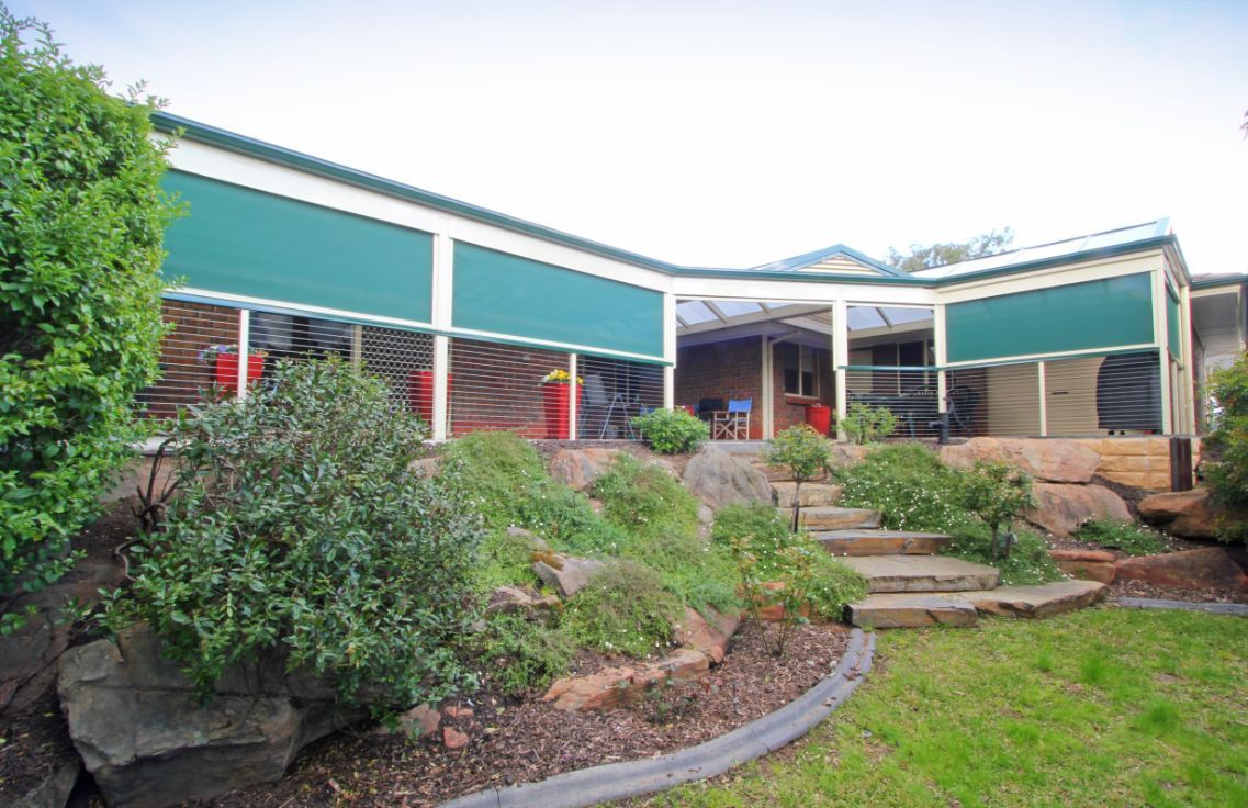 A Large House With a Covered Porch and Stairs Leading Up to It — South Burnett Garage Doors In Kingaroy, QLD