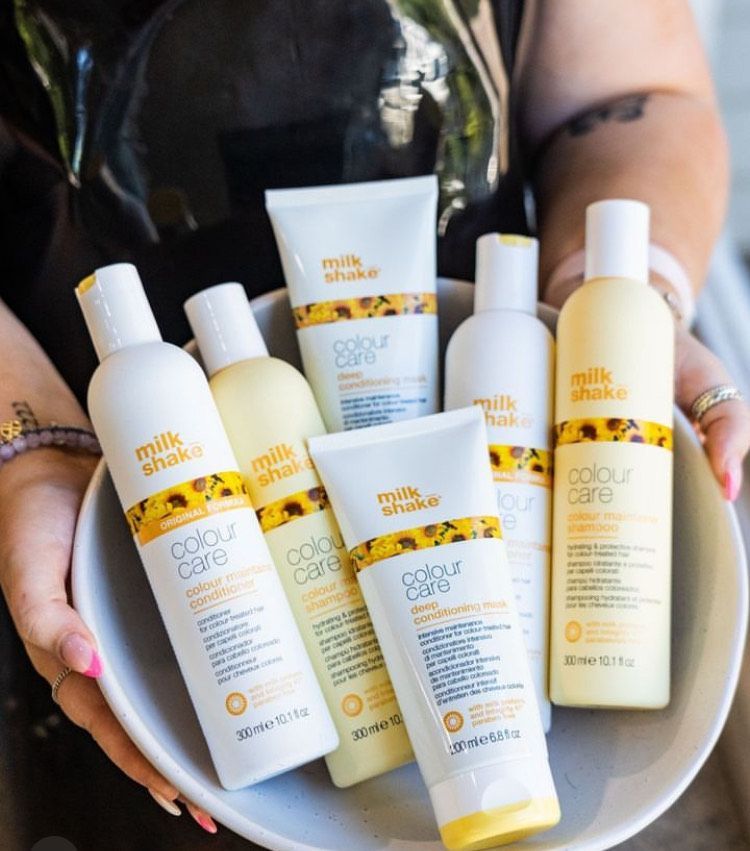 A woman is holding a bowl of milk shake products
