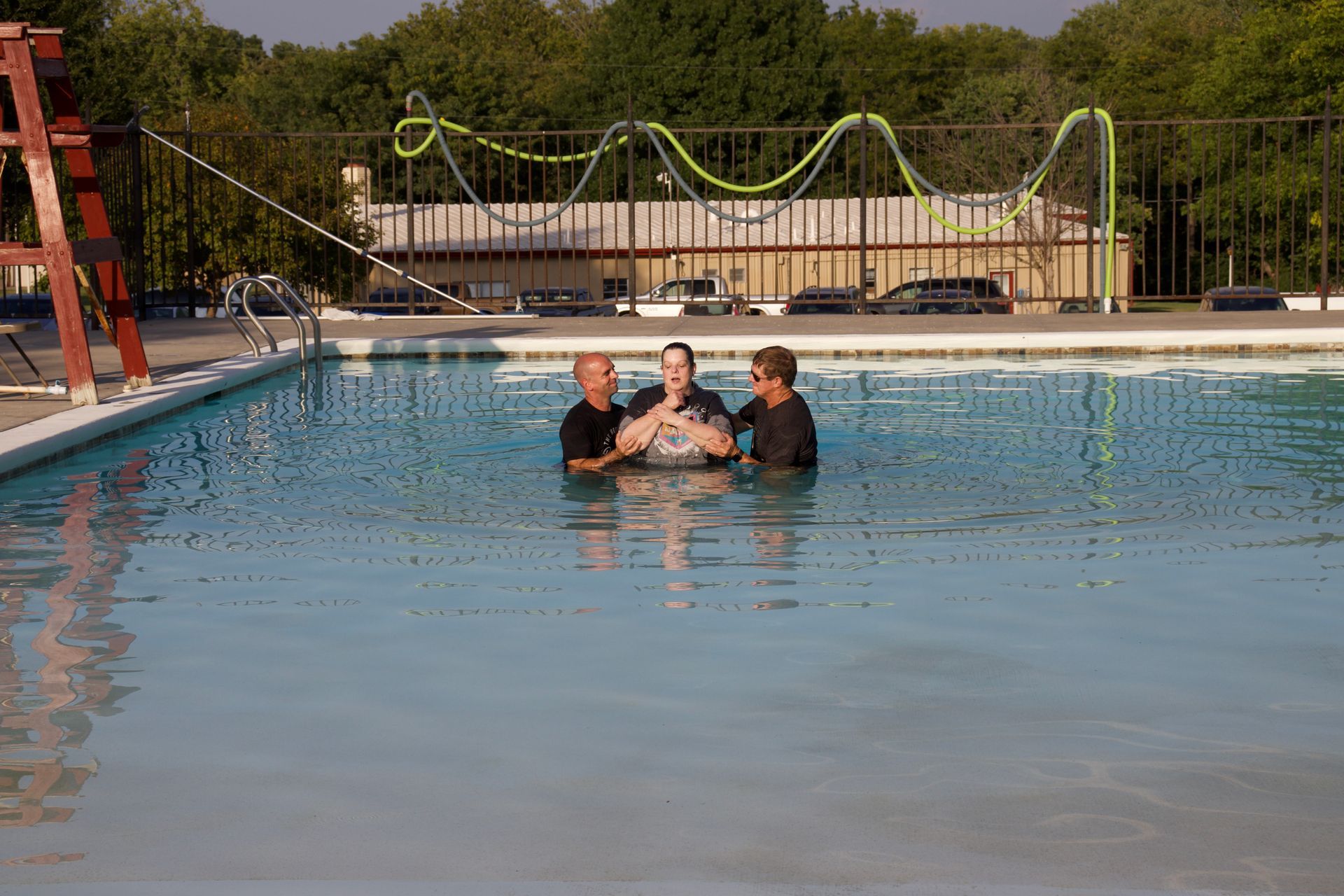 A group of people are standing in a swimming pool.