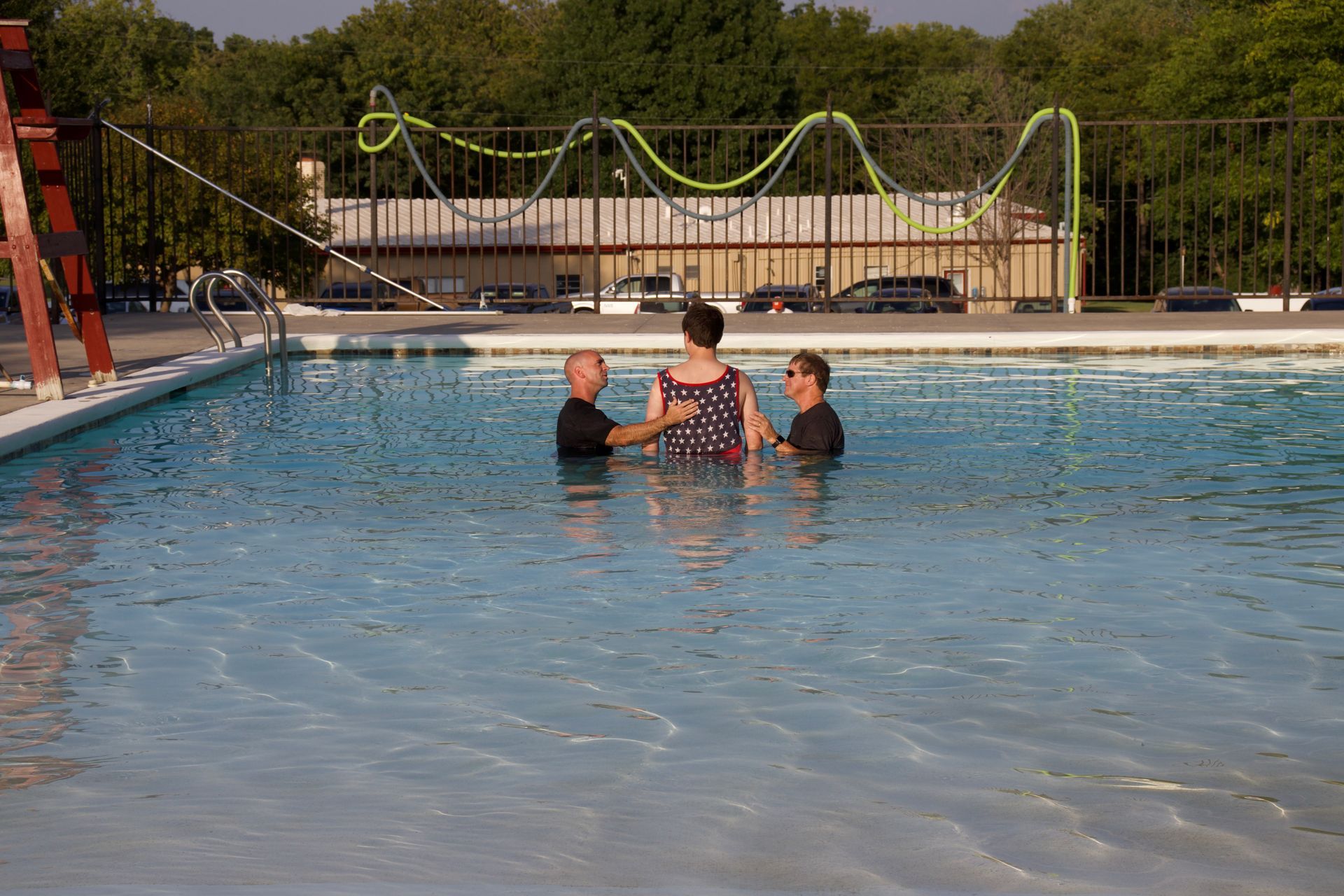 A group of people are standing in a swimming pool.