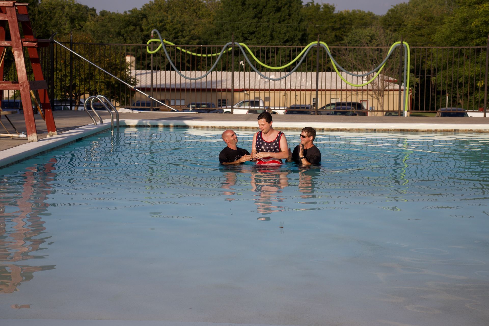 A group of people are standing in a swimming pool.