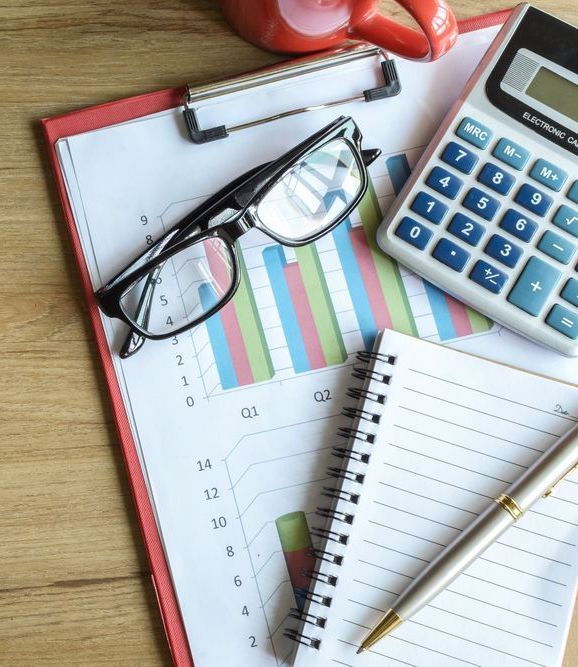 Report on the desk with reading glasses and calculator — Tax Accountant in Rockhampton, QLD