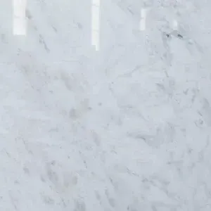 White marble slab with gray veining, highly reflective.