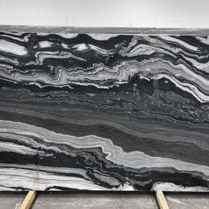 A large, black and white marble slab with wavy, layered patterns.