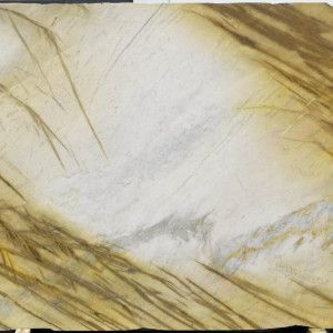 Creamy slab of stone with brown and gold veining.