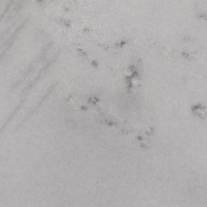 White marble with gray veining and small dark flecks.