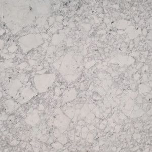 White marble surface with gray veining and speckled patterns.
