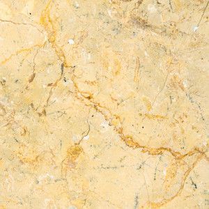 Yellow marble surface with brown veining and hairline cracks.